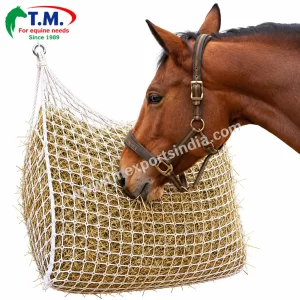 White rope mesh hay net shown with a horse feeding from hanging hay | T.M. Exports India