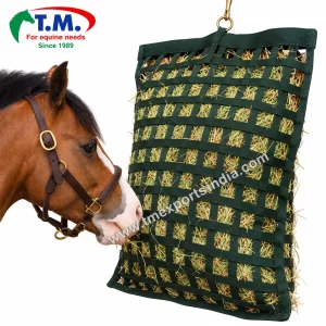 Forest green woven webbing hay feeder bag hanging beside a horse | T.M. Exports India