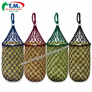 Blue burgundy green and black cylindrical rope hay nets filled with hay | T.M. Exports India