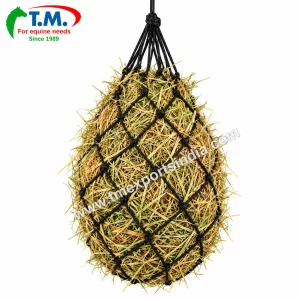 Black knotted rope hanging hay net filled with hay | T.M. Exports India