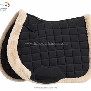 Charcoal grey saddle pad with square quilting, cream plush trim, and dark reinforced girth patch.