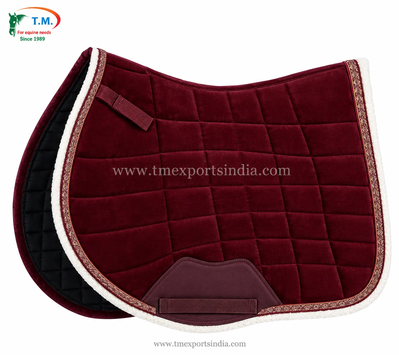 Burgundy quilted saddle pad with white plush edging, decorative patterned braid, and reinforced girth patch.