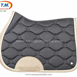 Charcoal grey saddle pad with diamond quilting, stitched decorative motifs, cream binding, and girth patch.