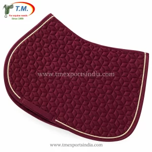 Burgundy saddle pad with geometric quilting, cream-colored decorative cord, and girth strap.
