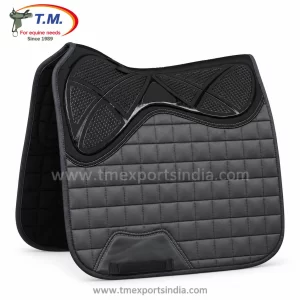 Charcoal grey dressage-cut saddle pad with fine quilting, black geometric textured upper panel, and girth reinforcement.
