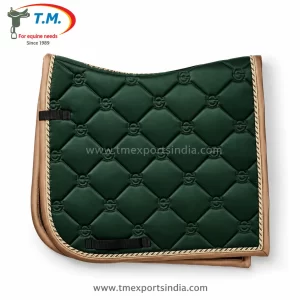 Dark green dressage-cut saddle pad with quilted diamond pattern, tan edging, and gold-colored decorative cord.