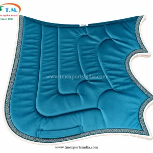 Bright teal shaped saddle pad with sculpted central panel, white piping, and patterned decorative edge trim.