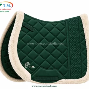 Emerald green saddle pad with diamond quilting, decorative vertical panel, and cream plush edging.